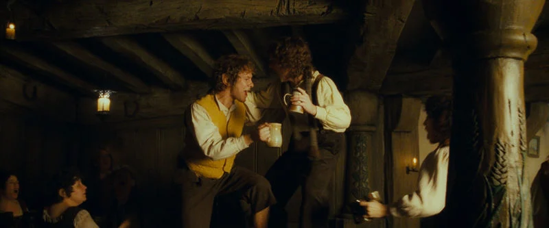 Merry and Pippin dancing in the Green Dragon in the Shire.